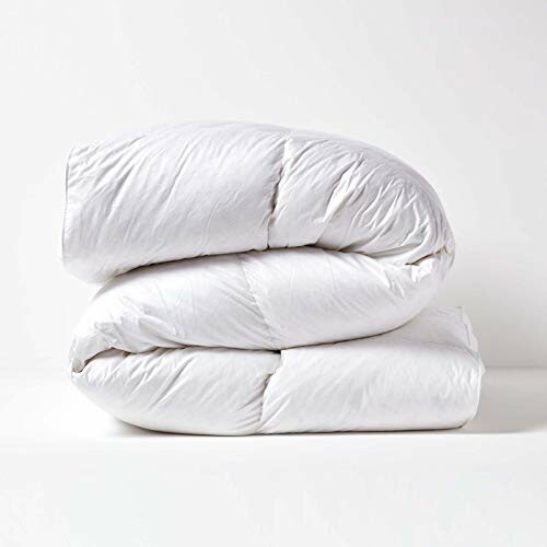 Folded white comforter on a plain background.