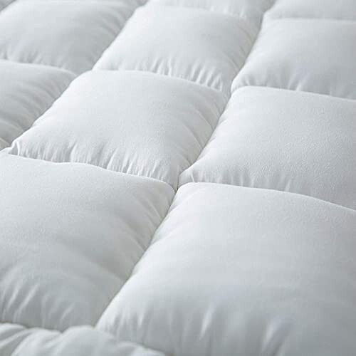 Close-up of soft white quilted fabric surface.